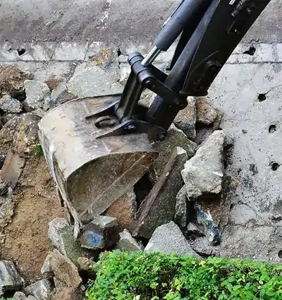 excavating-machine-digging-up-the-road excavating machine digging up the road